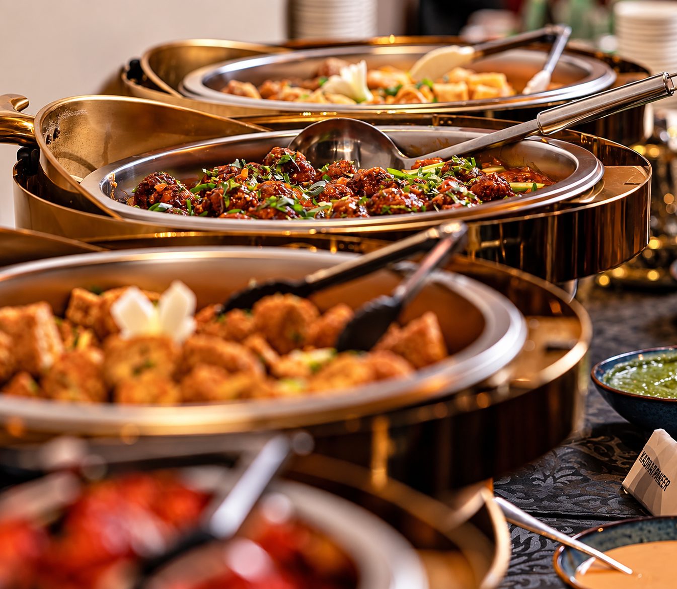 Chafing dishes of chilli chicken, paneer and curries on the Bombay Dreams buffet