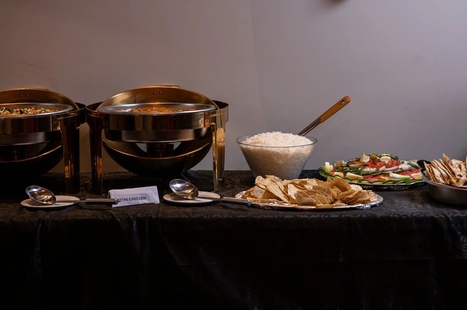 Catering buffet table with chafing dishes and rice