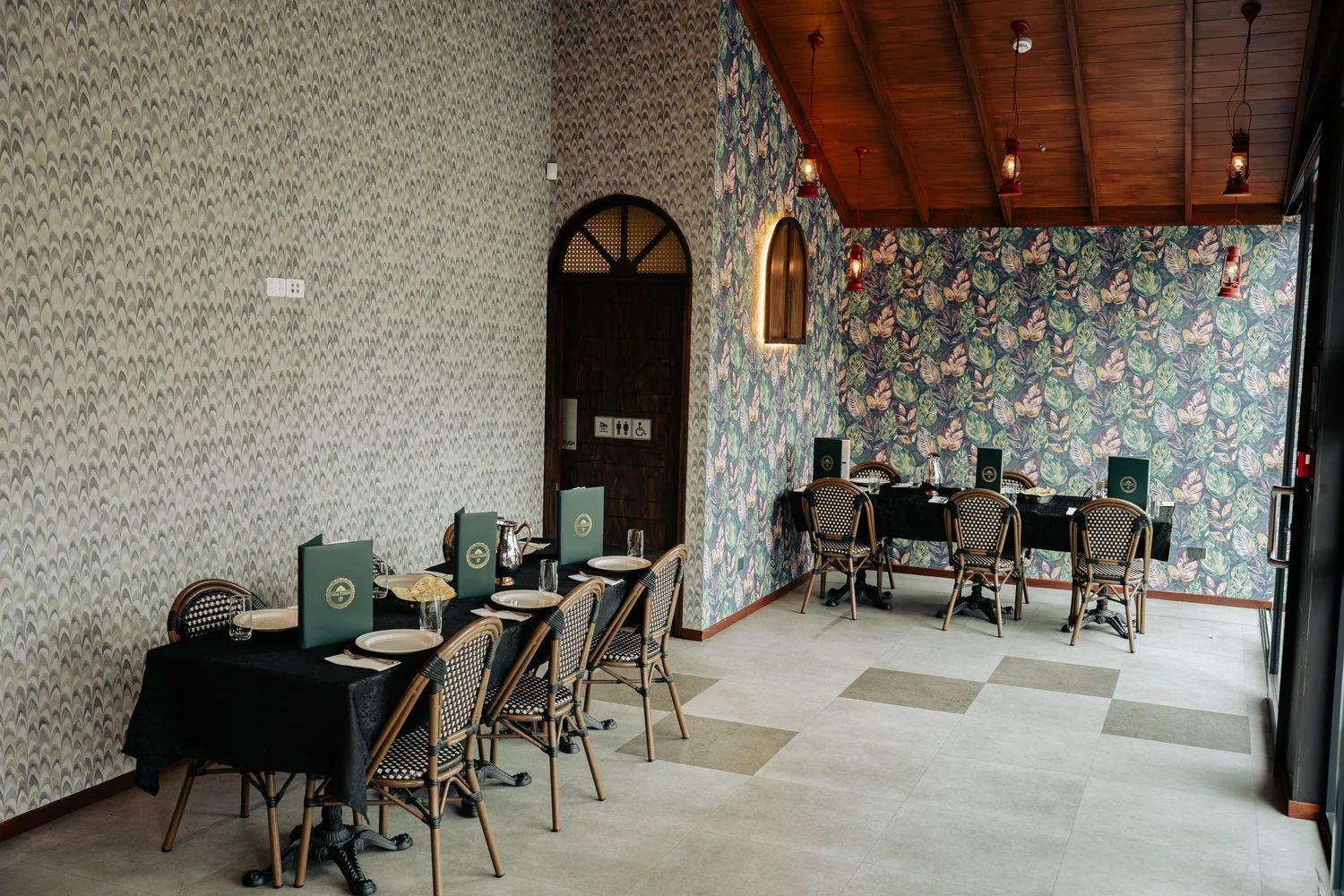 Front dining space with patterned feature wall and wooden ceiling